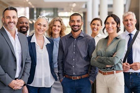 A group of smiling business professionals. Credit: https://www.istockphoto.com/au/portfolio/Ridofranz