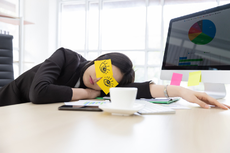 Business woman covertly sleeping with post-it notes over eyes. Credit: https://www.istockphoto.com/portfolio/x-reflexnaja