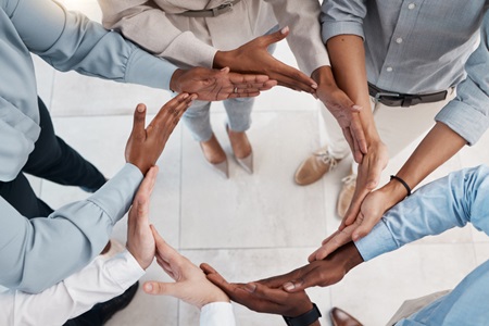 Multiple hands forming a circle. Credit: https://www.istockphoto.com/portfolio/PeopleImages